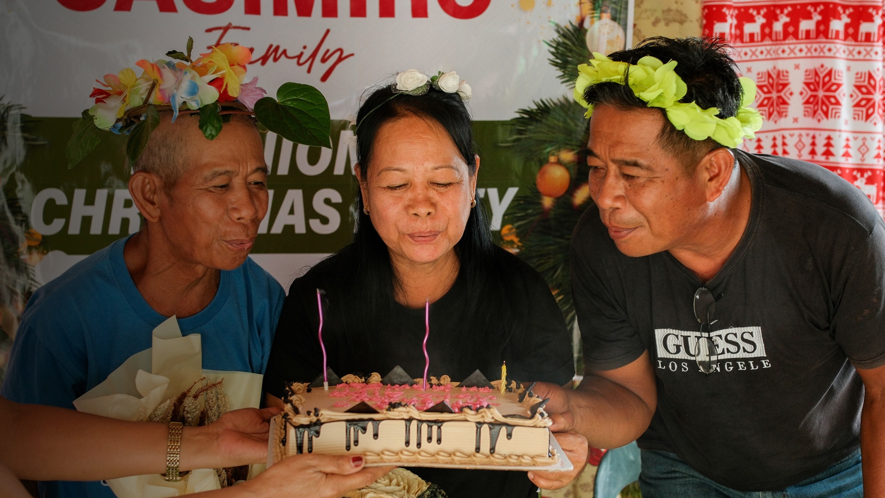 Filipino family celebration — cake, flowers, and festive gathering